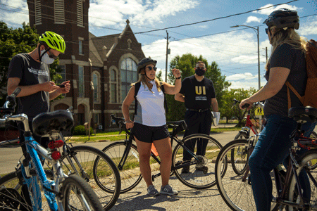 Adrienne Miller, planner and economic development specialist for the City of Waterloo, leads the University of Iowa visitors on the bike tour through the Church Row neighborhood.