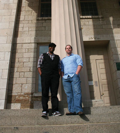 Nicholas Yanes and Derrais Carter stand in front of a building on the pentacrest