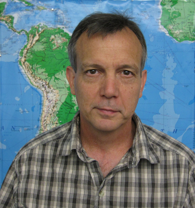 David Bennett stands in front of a map and looks into the camera