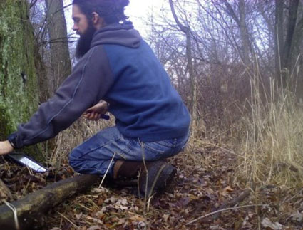 Brandon MacDougall uses a trail camera to conduct his research.