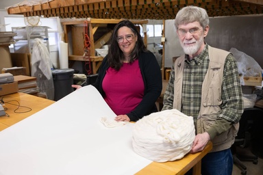 Sara Langworthy and Tim Barrett with conservation papers at the UICB Oakdale facility