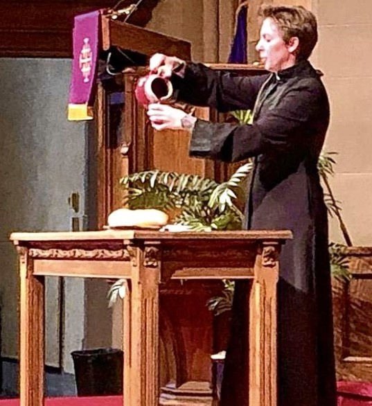 Metcalfe at a podium in a church