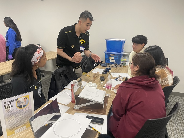 Martin leads a psychology and neuroscience station at a STEM event with students from West Liberty High School. Photo provided by Ashby Martin.