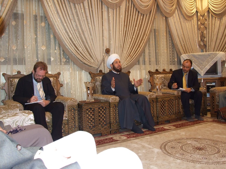 Chris Merrill (left) with a mufti and an interpreter on a visit to the Middle East, 2007
