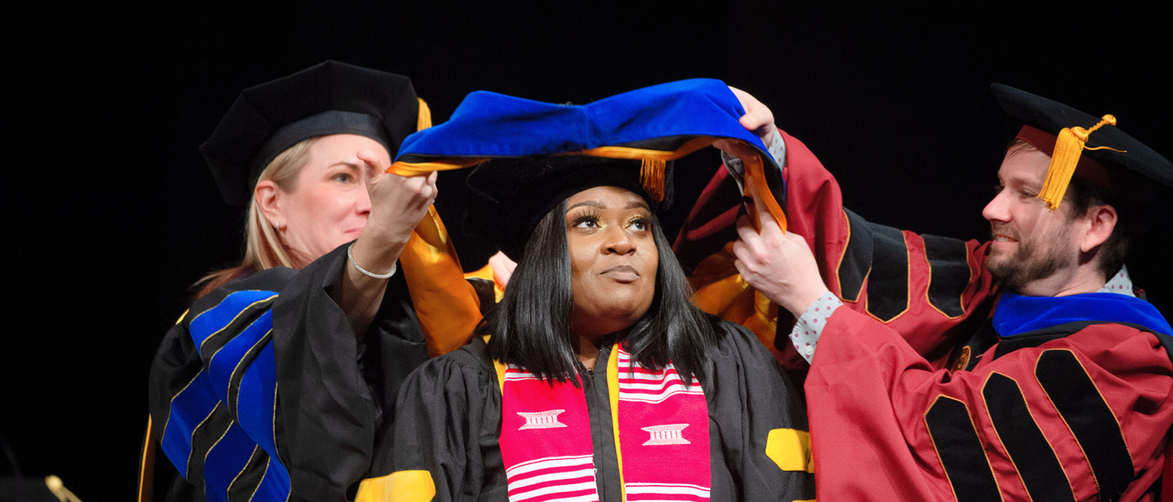 A graduate student is hooded during the Doctoral Commencement Ceremony.