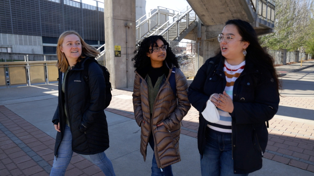 Left to left: University of Iowa students Alex Murra, Radha Velamuri, and Eliza Steere walk to the College of Public Health.